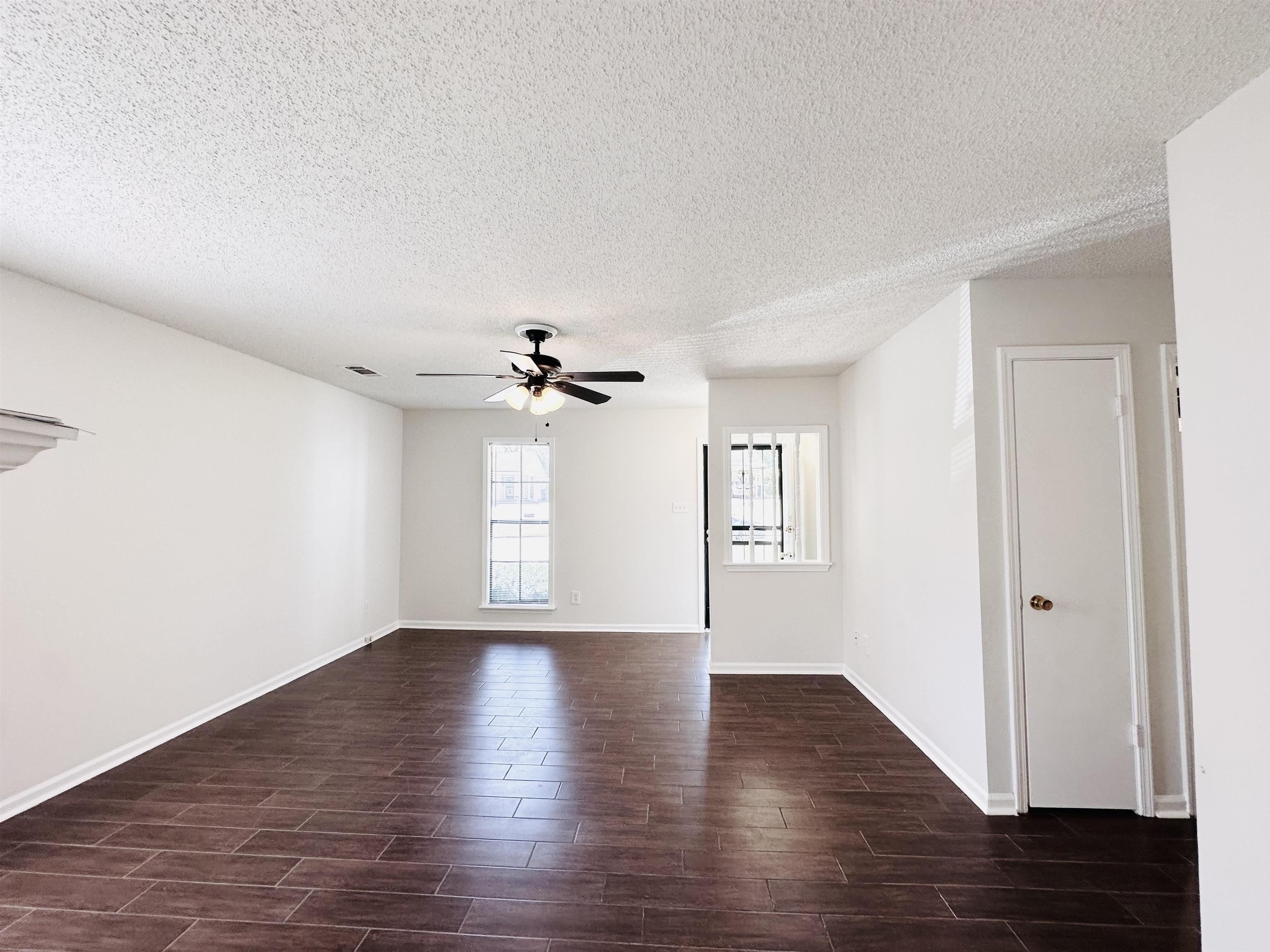 4192 Riche Road Memphis, TN 38128 - Photo 6 of 32 a view of an empty room with a window and wooden floor