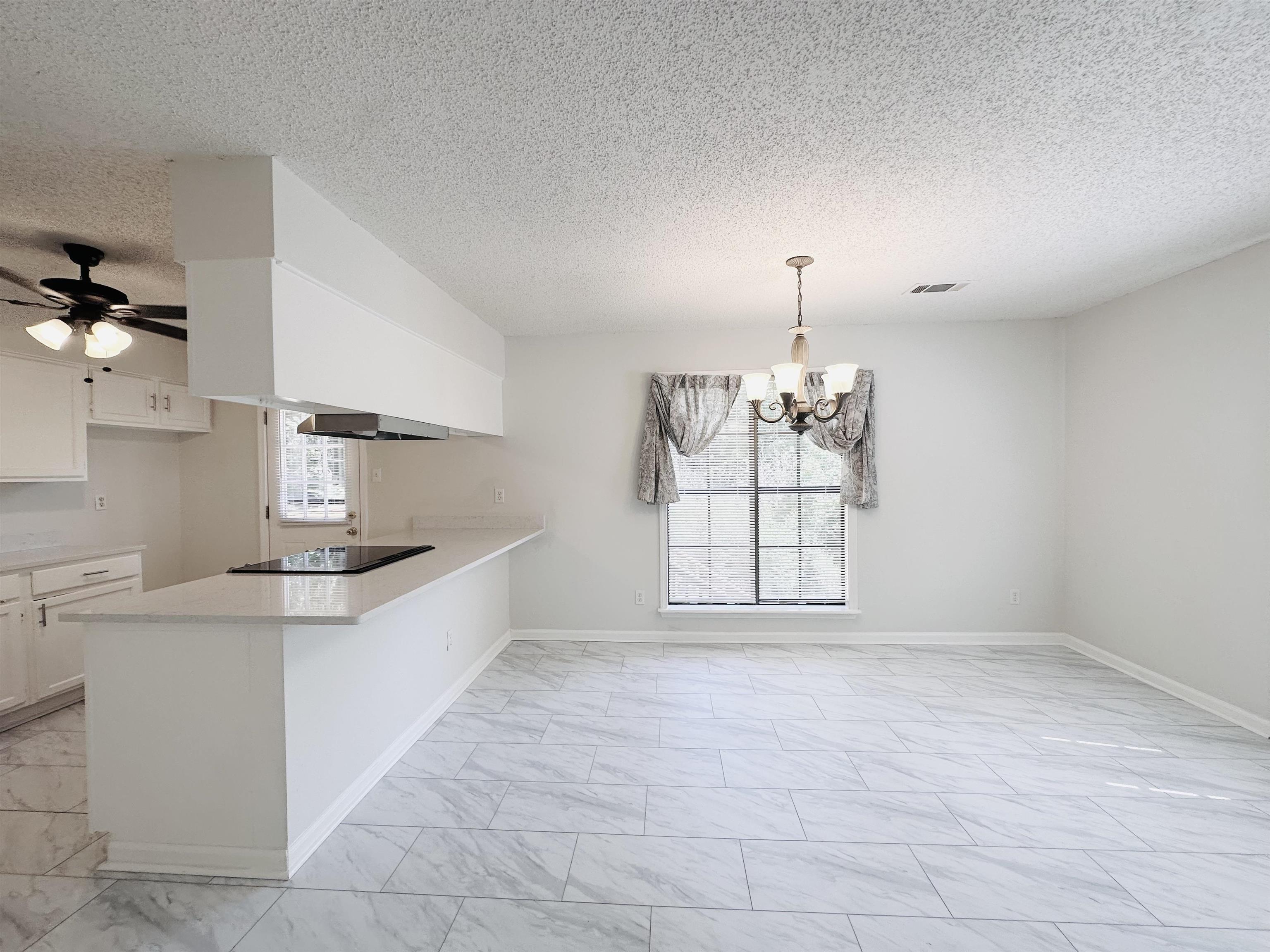 4192 Riche Road Memphis, TN 38128 - Photo 8 of 32 a view of a kitchen with a sink dishwasher and a wooden floor