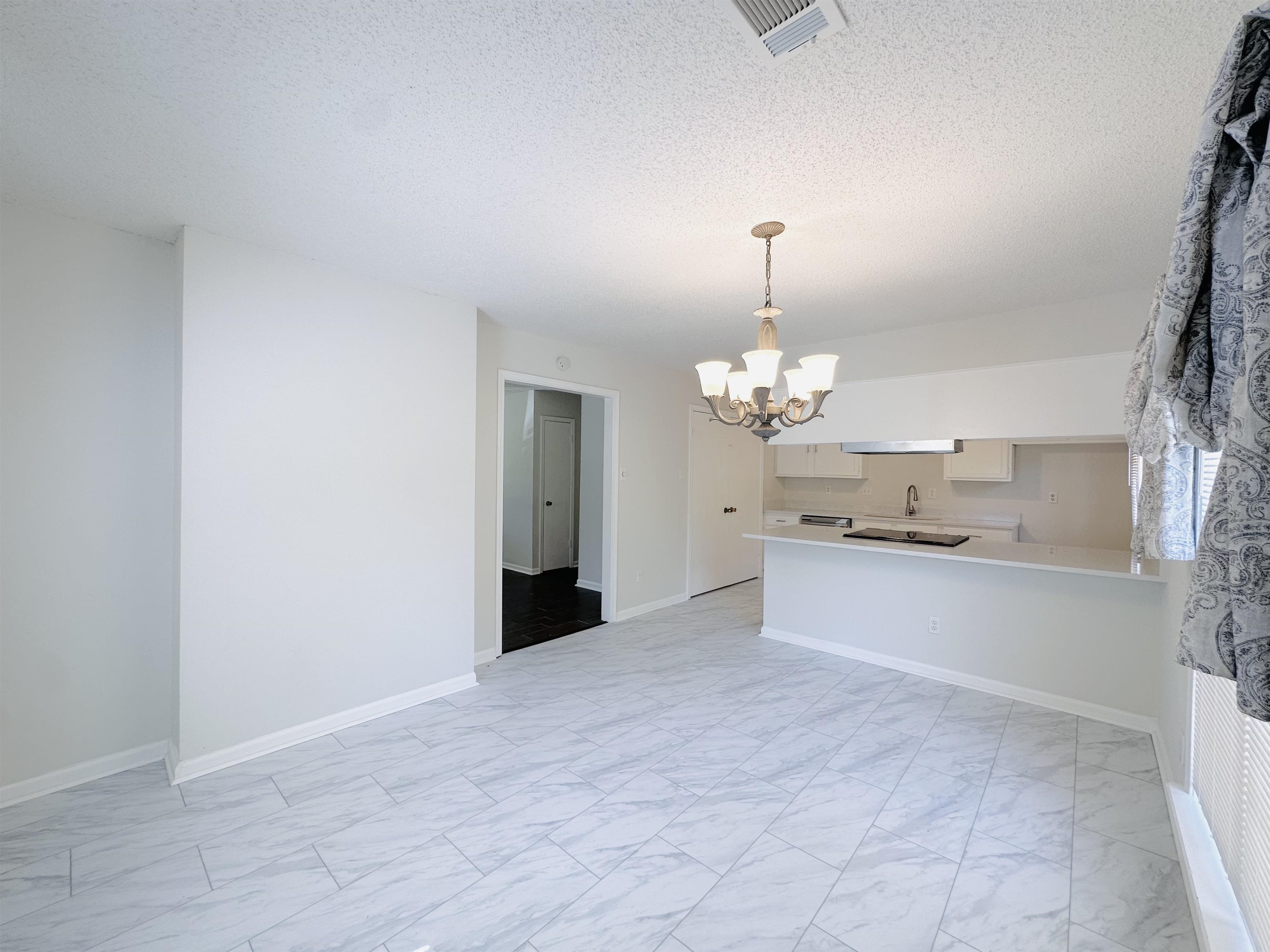 4192 Riche Road Memphis, TN 38128 - Photo 9 of 32 a large kitchen with a refrigerator and chandelier