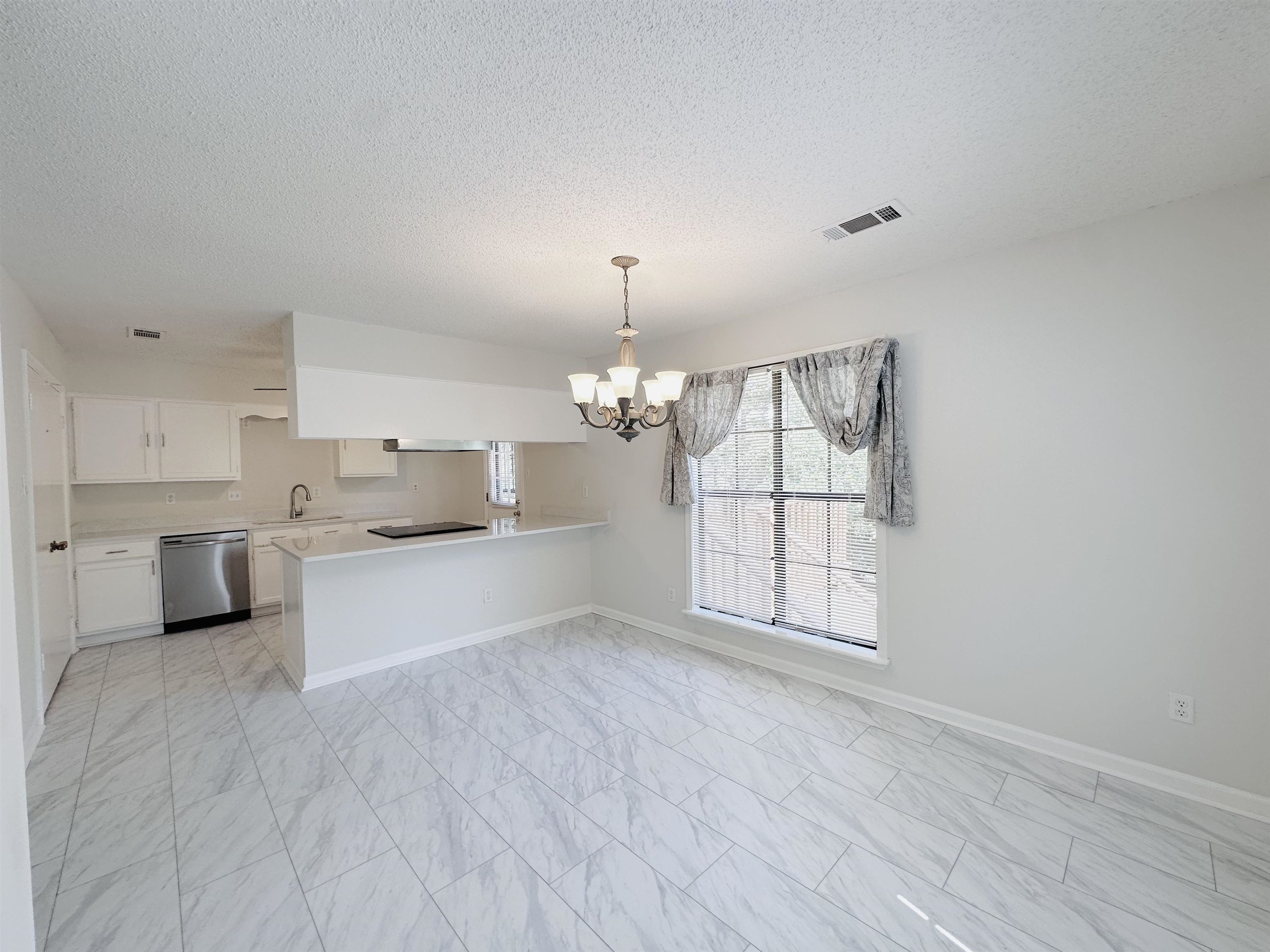4192 Riche Road Memphis, TN 38128 - Photo 10 of 32 a large white kitchen with cabinets a sink and a wooden floor