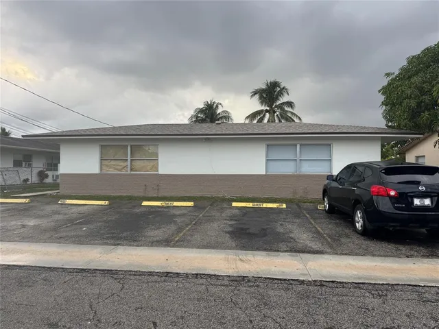 a view of a car parked in front of a house