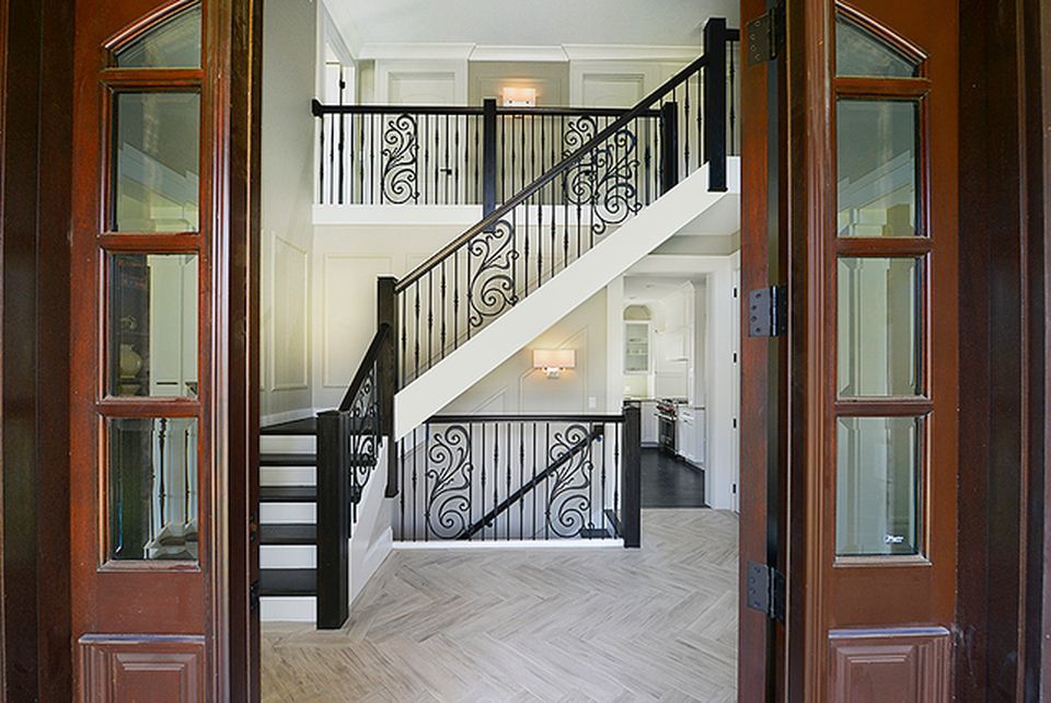 330 Brookside Lane Glencoe, IL 60022 - Photo 2 of 40 a view of staircase with wooden floor and a floor to ceiling window