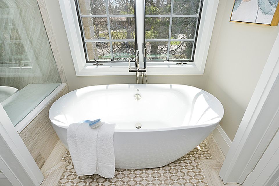 330 Brookside Lane Glencoe, IL 60022 - Photo 21 of 40 a white bath tub sitting in a bathroom next to a window