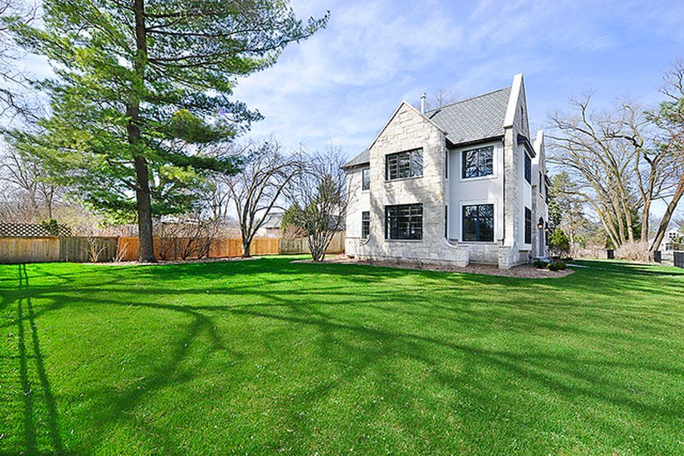 330 Brookside Lane Glencoe, IL 60022 - Photo 38 of 40 a view of a white house with a big yard and large trees