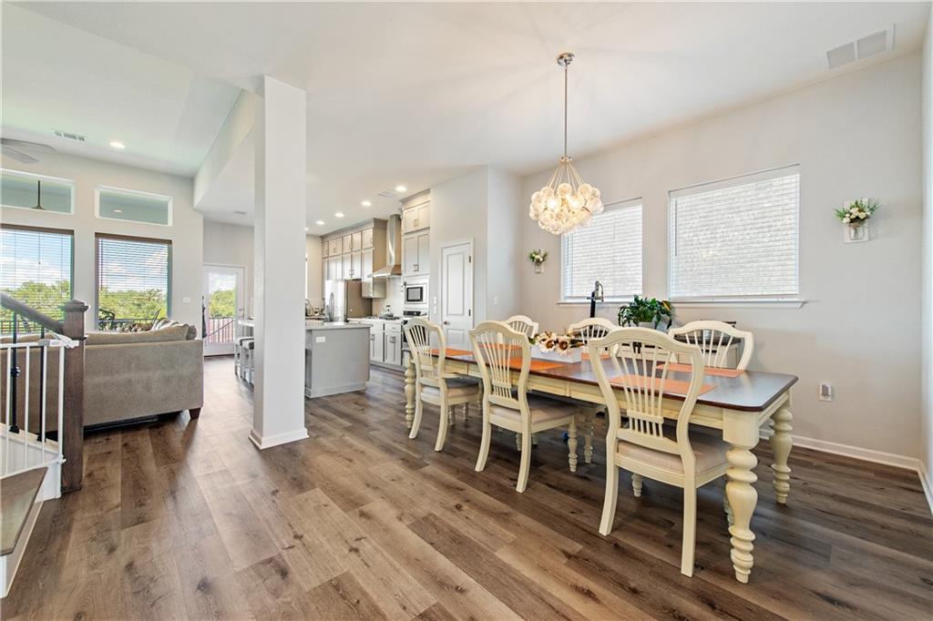 7117 Jument Drive Austin, TX 78738 - Photo 13 of 40 Dining space featuring healthy amount of natural light, wood finished floors, a chandelier, and recessed lighting