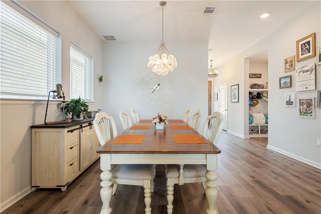 7117 Jument Drive Austin, TX 78738 - Photo 15 of 40 Dining room featuring dark wood-style floors, a chandelier, and recessed lighting