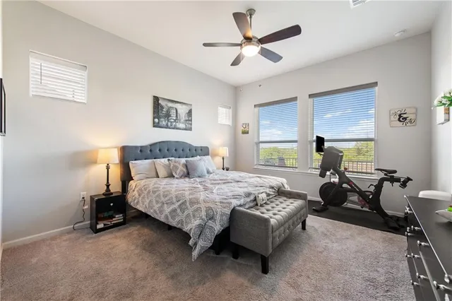 a bedroom with a bed gym equipment and window