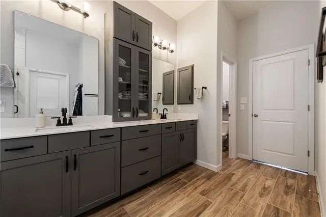 a spacious bathroom with a double vanity sink double and mirror