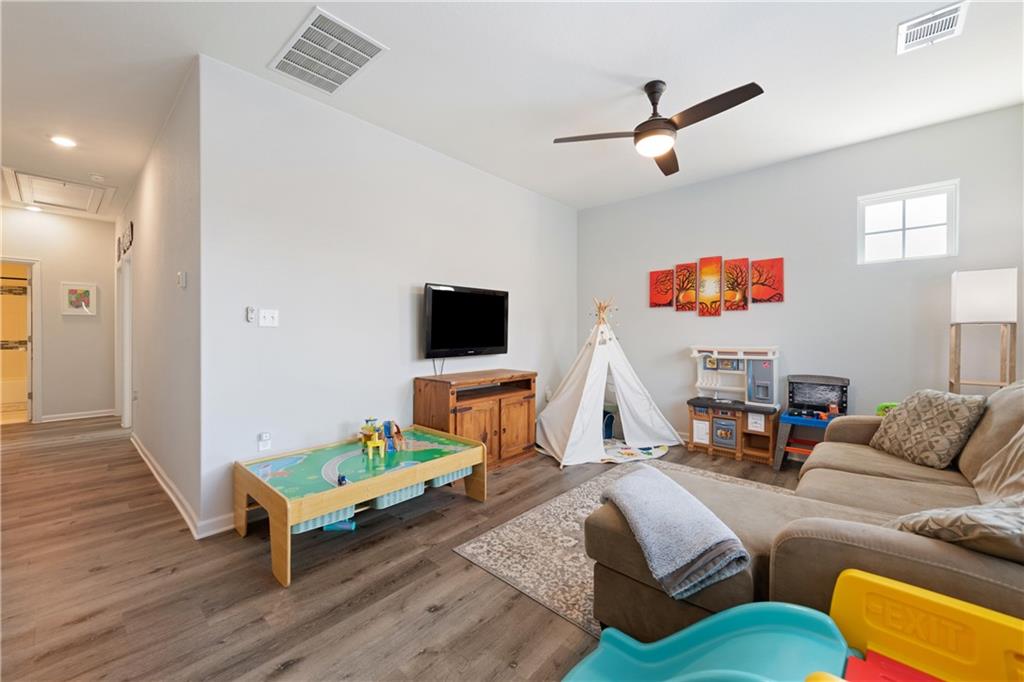 7117 Jument Drive Austin, TX 78738 - Photo 24 of 40 Living area with a ceiling fan, attic access, wood finished floors, and recessed lighting