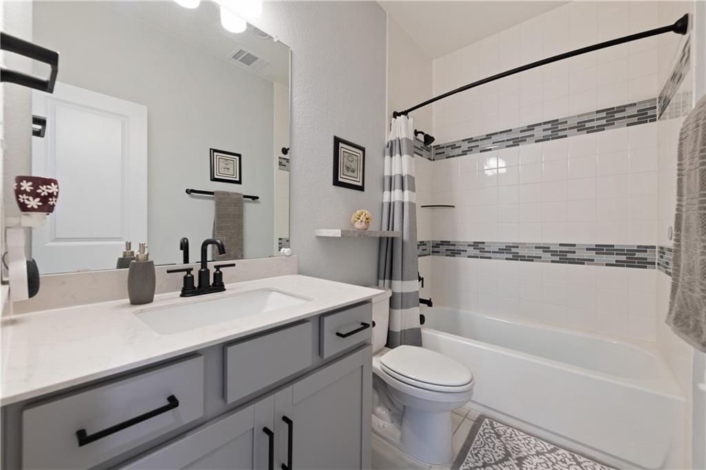 7117 Jument Drive Austin, TX 78738 - Photo 25 of 40 Full bath with vanity, shower / bath combo, and tile patterned flooring