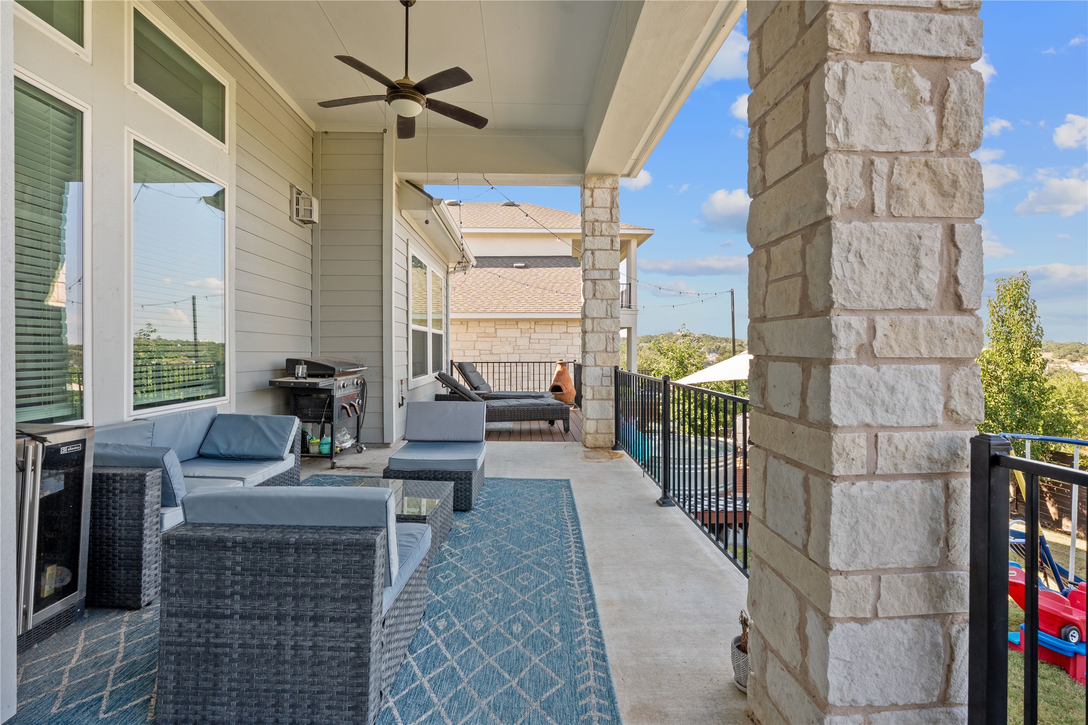 7117 Jument Drive Austin, TX 78738 - Photo 32 of 40 View of patio / terrace featuring a ceiling fan, a grill, an outdoor living space, and beverage cooler