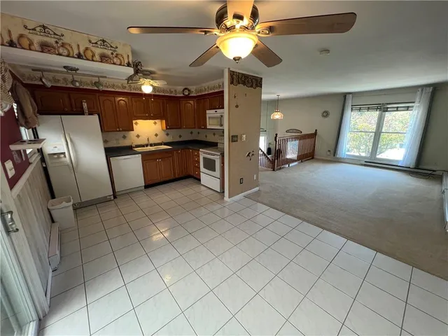 a large kitchen with cabinets and stainless steel appliances