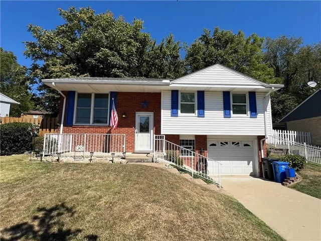 a front view of a house with garage