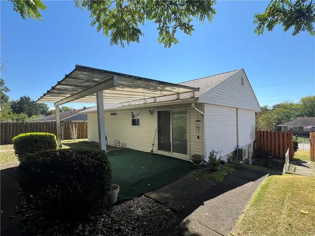 a front view of house with yard and outdoor seating