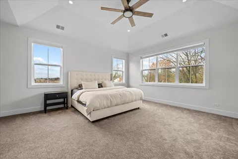 a spacious bedroom with a bed and a window