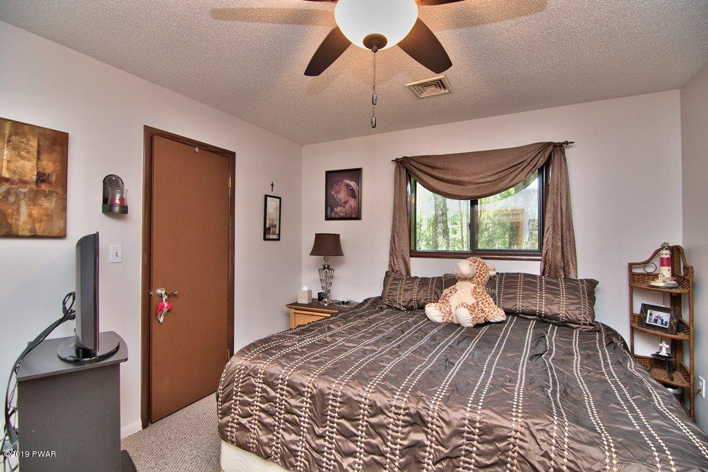 3151 Northgate Road Lake Ariel, PA 18436 - Photo 34 of 68 a bedroom with a bed and wooden floor