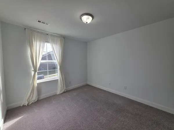 an empty room with a empty space and windows