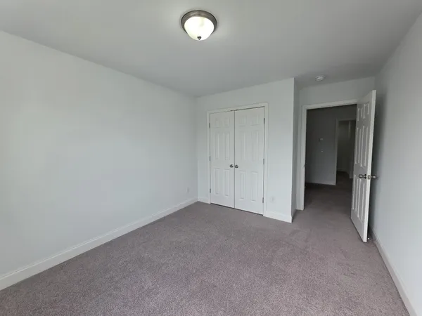 an empty room with closet area