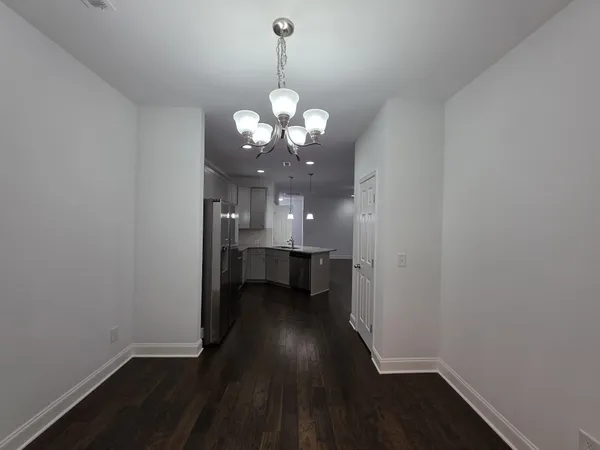 a view of a hallway to dining room and wooden floor