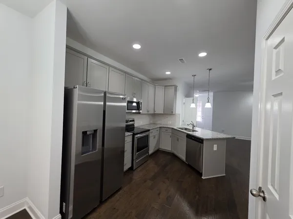 a kitchen with refrigerator and cabinets