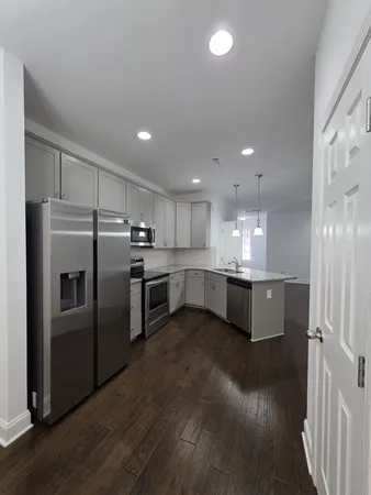 a large kitchen with a large window and stainless steel appliances
