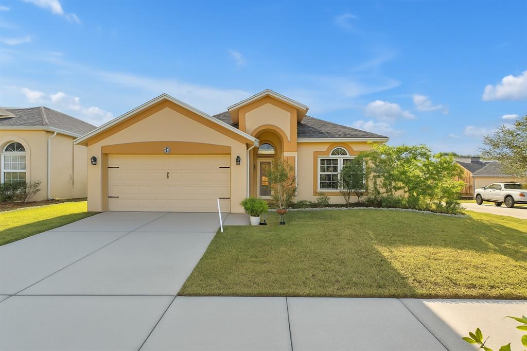 1709 Open Field Loop Brandon, FL 33510 - Photo 1 of 1 a front view of a house with a yard and garage