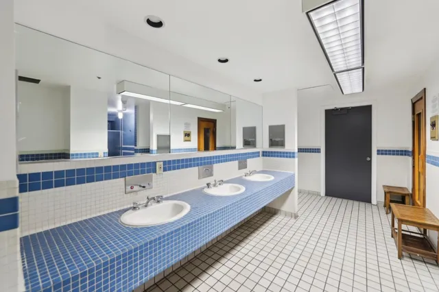 a bathroom with a sink double vanity granite and a mirror
