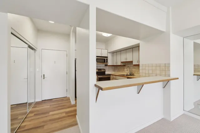 a kitchen with stainless steel appliances granite countertop a refrigerator and a sink