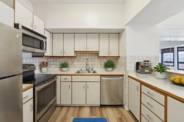 a kitchen with stainless steel appliances granite countertop a sink and cabinets