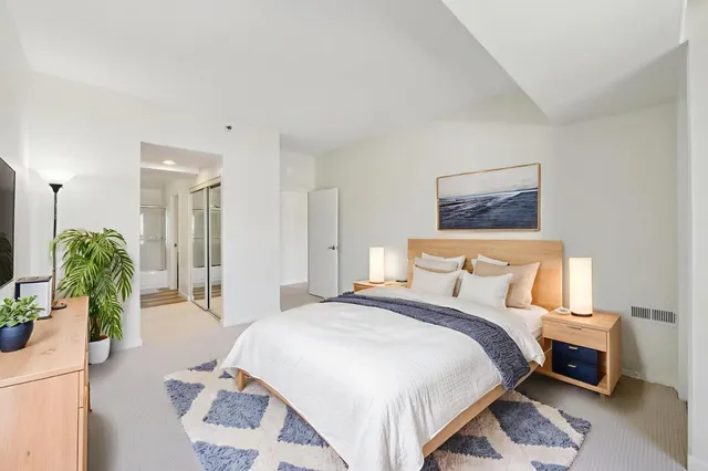 a spacious bedroom with a bed and a couch