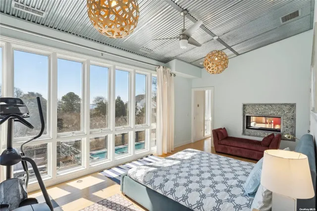 a bedroom with furniture and a large window