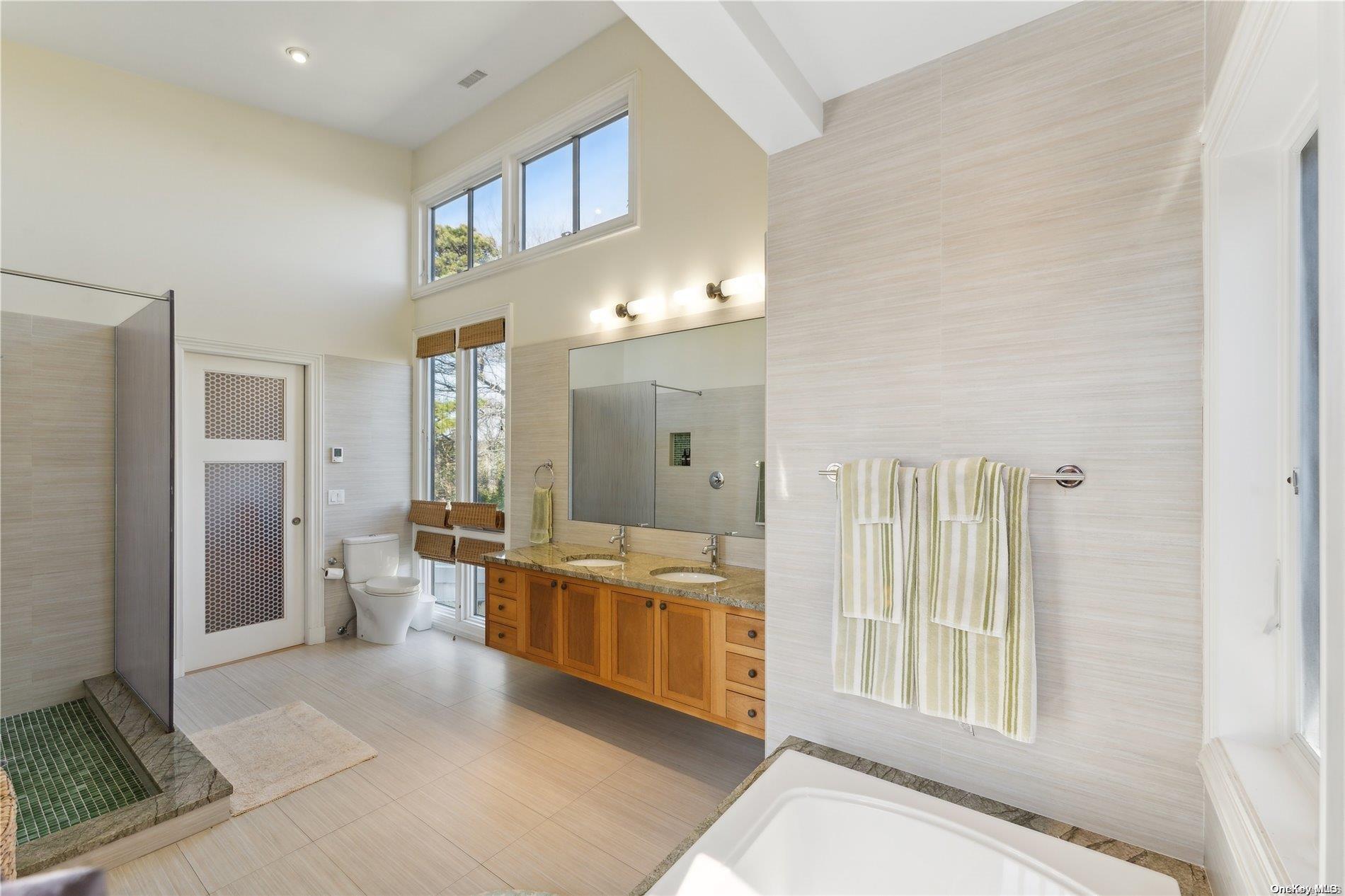 32 Tuthill Lane Remsenburg, NY 11960 - Photo 13 of 32 a living room with furniture and large windows