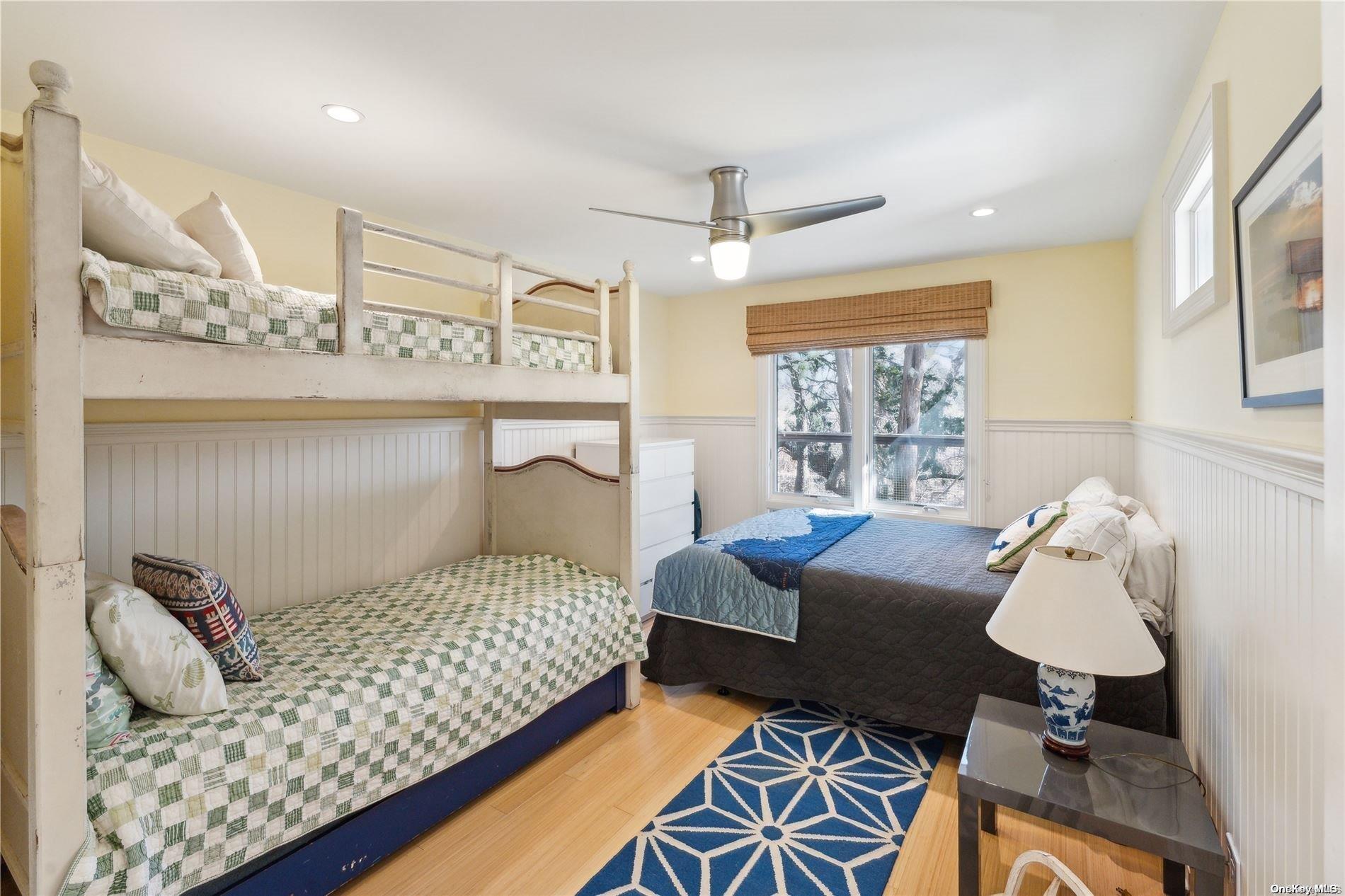 32 Tuthill Lane Remsenburg, NY 11960 - Photo 20 of 32 a bedroom with a bed and wooden floor