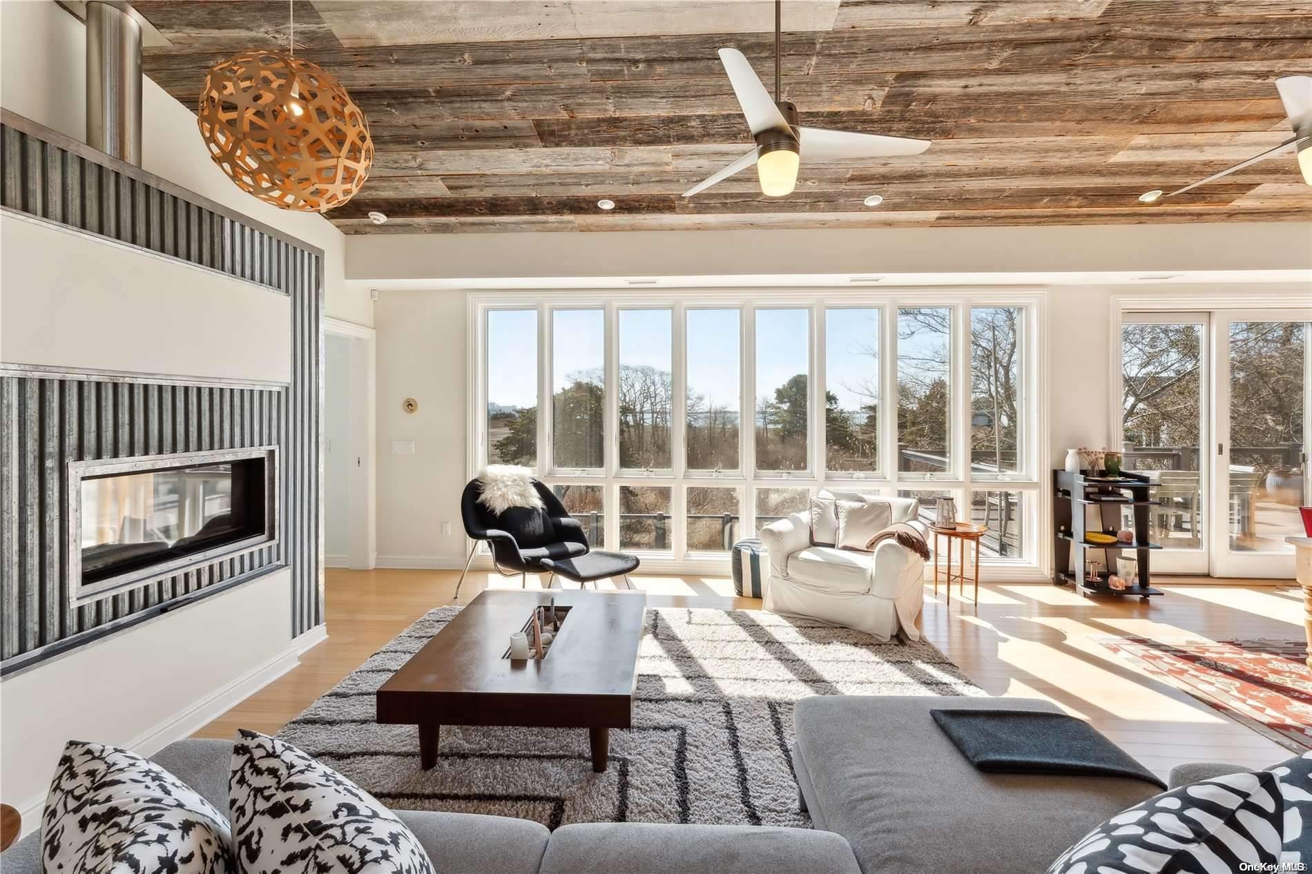 32 Tuthill Lane Remsenburg, NY 11960 - Photo 2 of 32 a living room with furniture and a floor to ceiling window