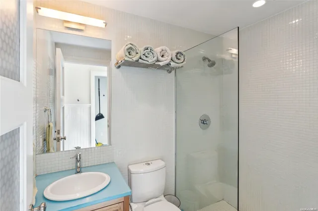 a bathroom with a toilet a sink and a shower