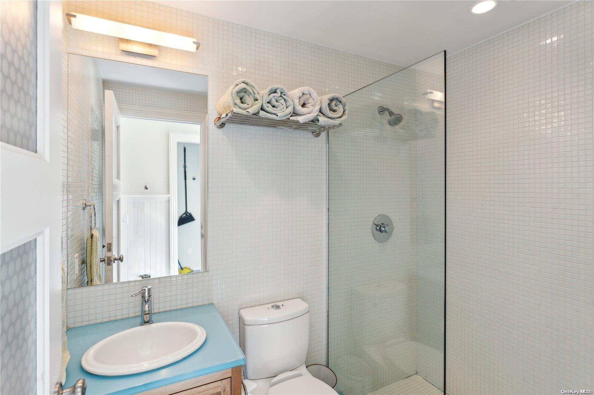 32 Tuthill Lane Remsenburg, NY 11960 - Photo 21 of 32 a bathroom with a toilet a sink and a shower