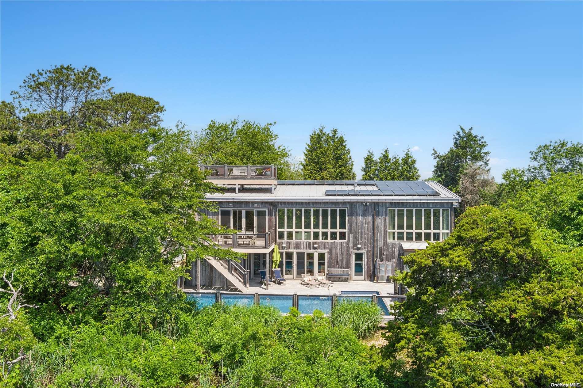 32 Tuthill Lane Remsenburg, NY 11960 - Photo 28 of 32 front view of a house with a small yard