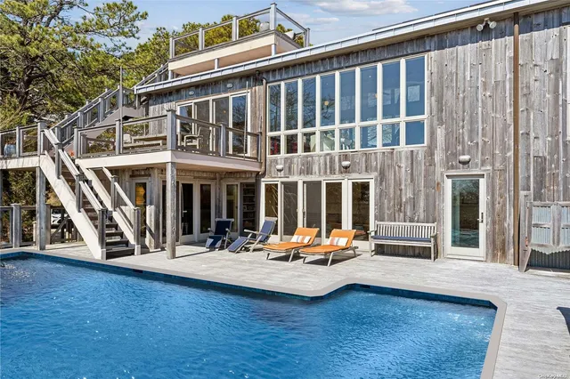 a view of a building with sitting area and furniture