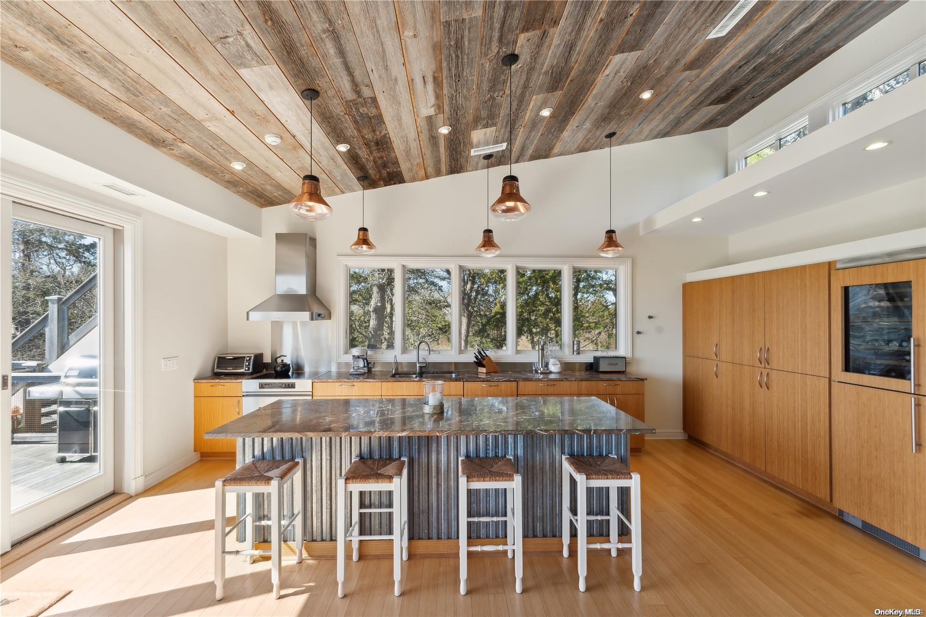 32 Tuthill Lane Remsenburg, NY 11960 - Photo 10 of 32 a dining room with furniture large windows and wooden floor