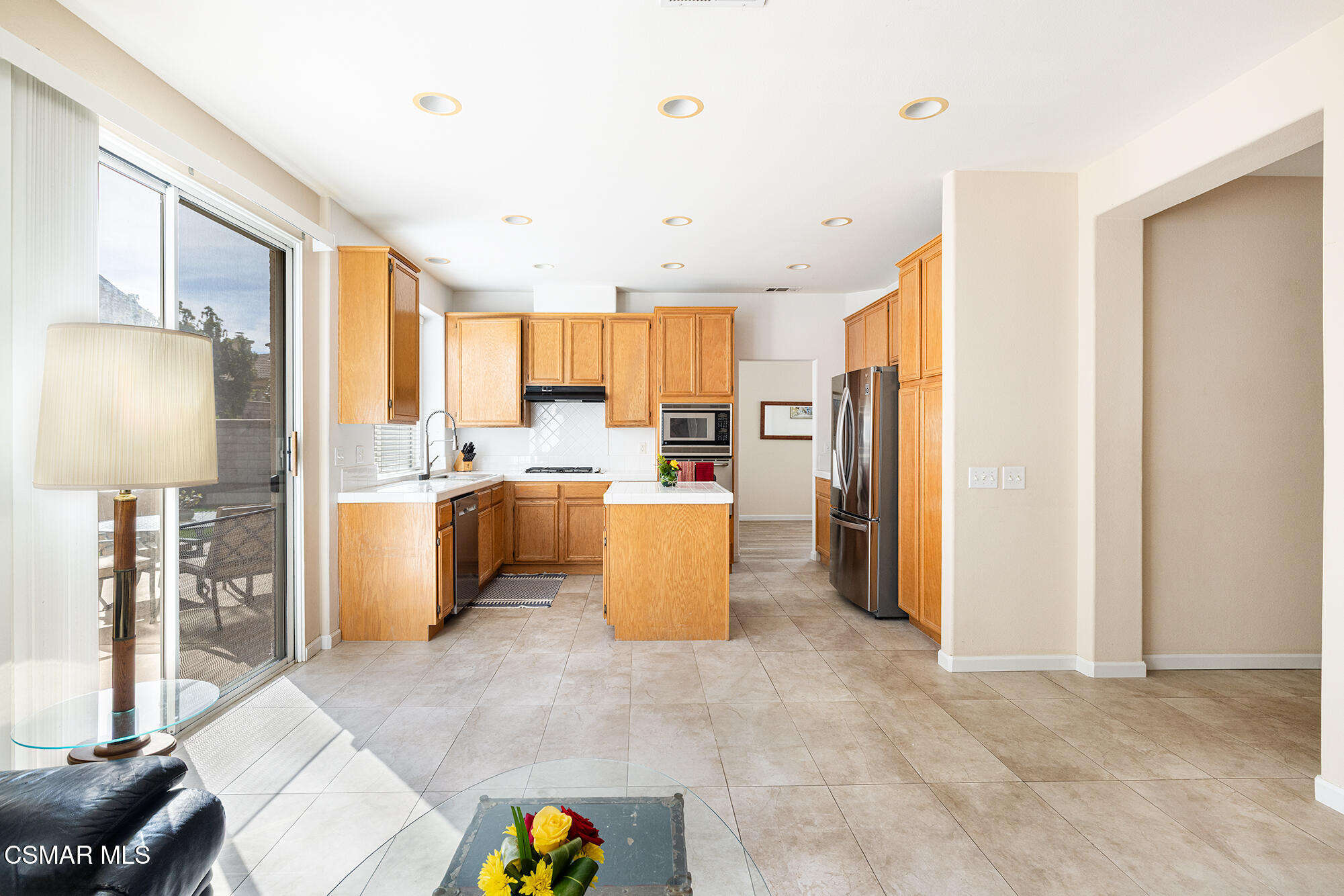 2684 Sunshine Valley Court Simi Valley, CA 93063 - Photo 27 of 38 a kitchen with stainless steel appliances a refrigerator a stove a sink a dining table and chairs
