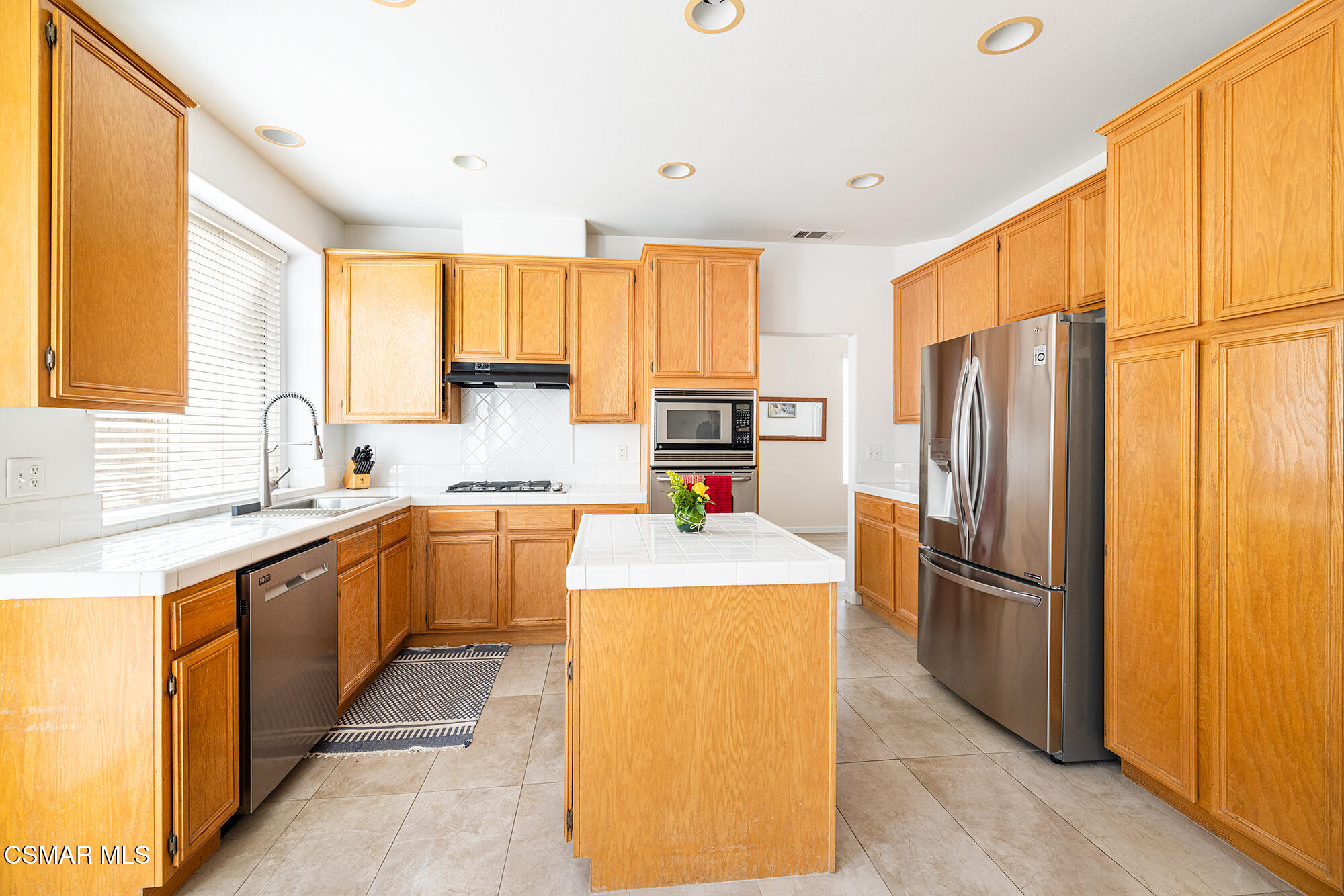 2684 Sunshine Valley Court Simi Valley, CA 93063 - Photo 28 of 38 a kitchen with stainless steel appliances a refrigerator sink and white cabinets