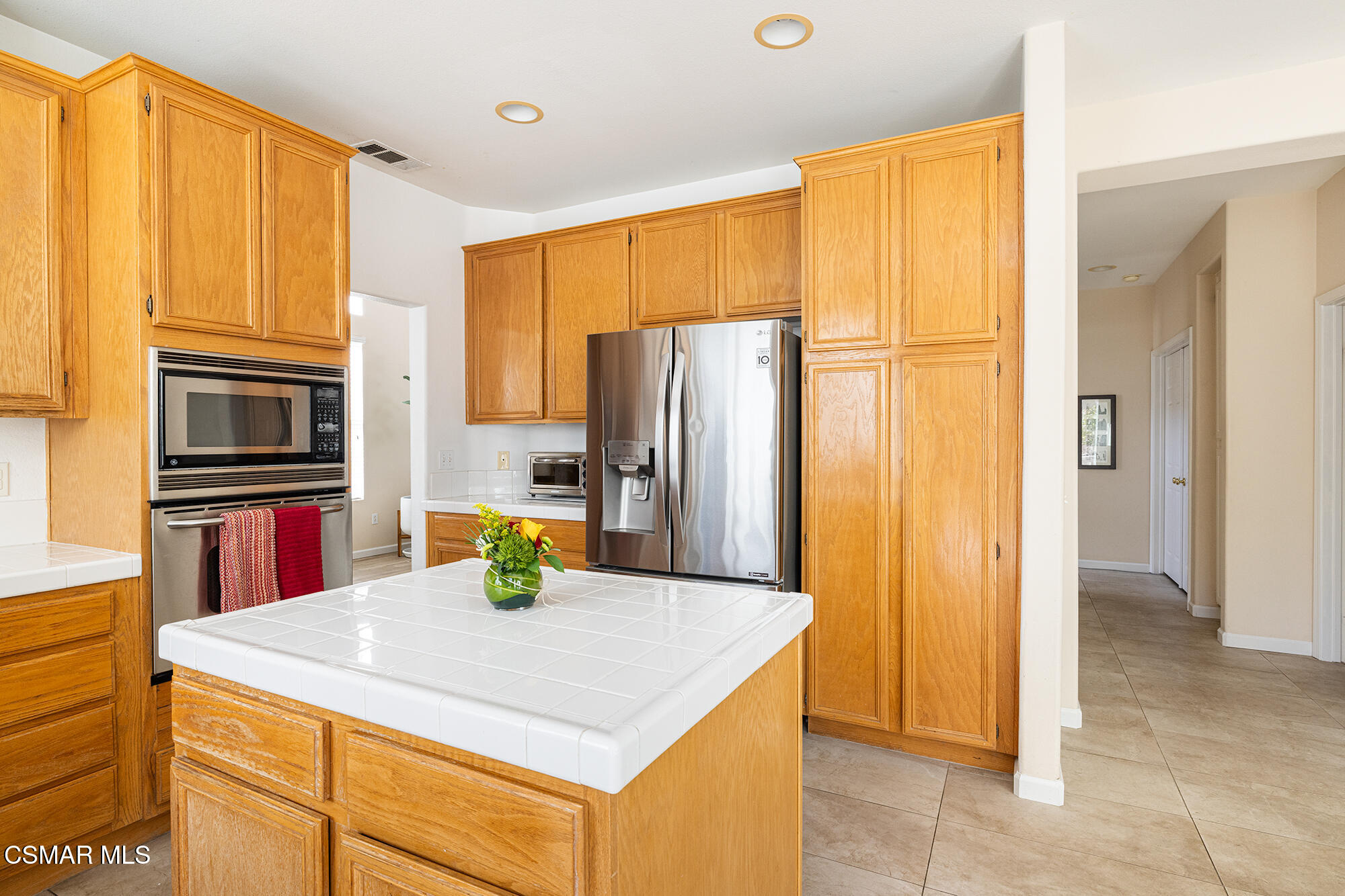 2684 Sunshine Valley Court Simi Valley, CA 93063 - Photo 30 of 38 a kitchen with stainless steel appliances a refrigerator sink and wooden cabinets