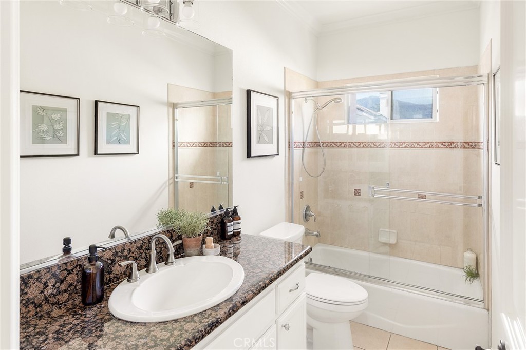525 Fifth Avenue, Unit B Arcadia, CA 91006 - Photo 10 of 12 a bathroom with a granite countertop sink toilet a mirror and shower