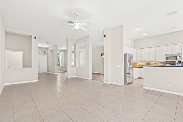 a view of a kitchen with refrigerator and cabinets
