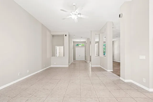 a kitchen with stainless steel appliances granite countertop a refrigerator a stove a sink and white cabinets