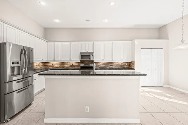 a kitchen with stainless steel appliances a stove sink and microwave