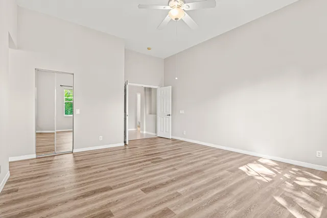 a spacious bathroom with a granite countertop sink a mirror and a bathtub