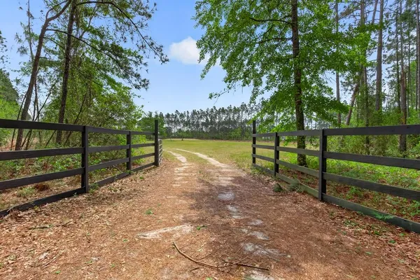 a view of park with wooden fence
