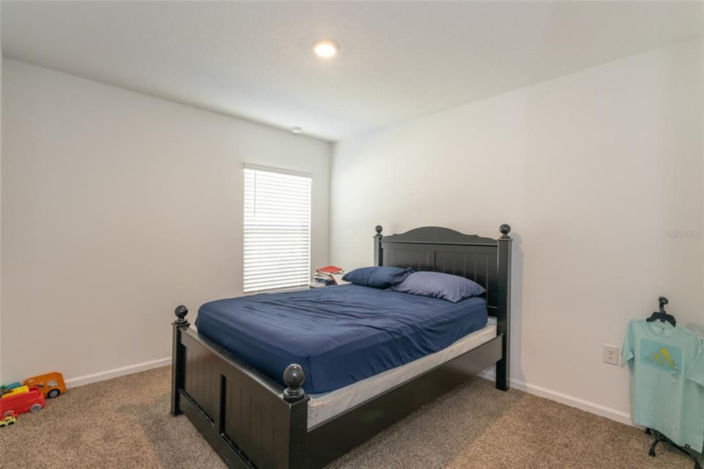 18 Bogey Place Bunnell, FL 32110 - Photo 15 of 40 a spacious bedroom with a bed and a window