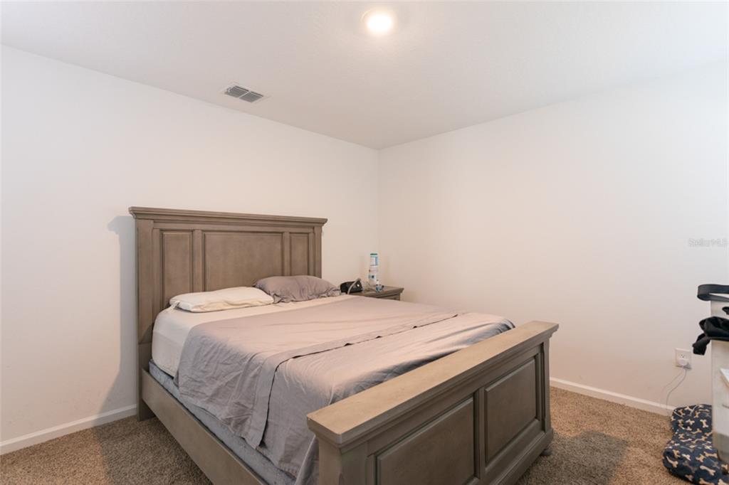 18 Bogey Place Bunnell, FL 32110 - Photo 16 of 40 a bedroom with a bed and wooden floor